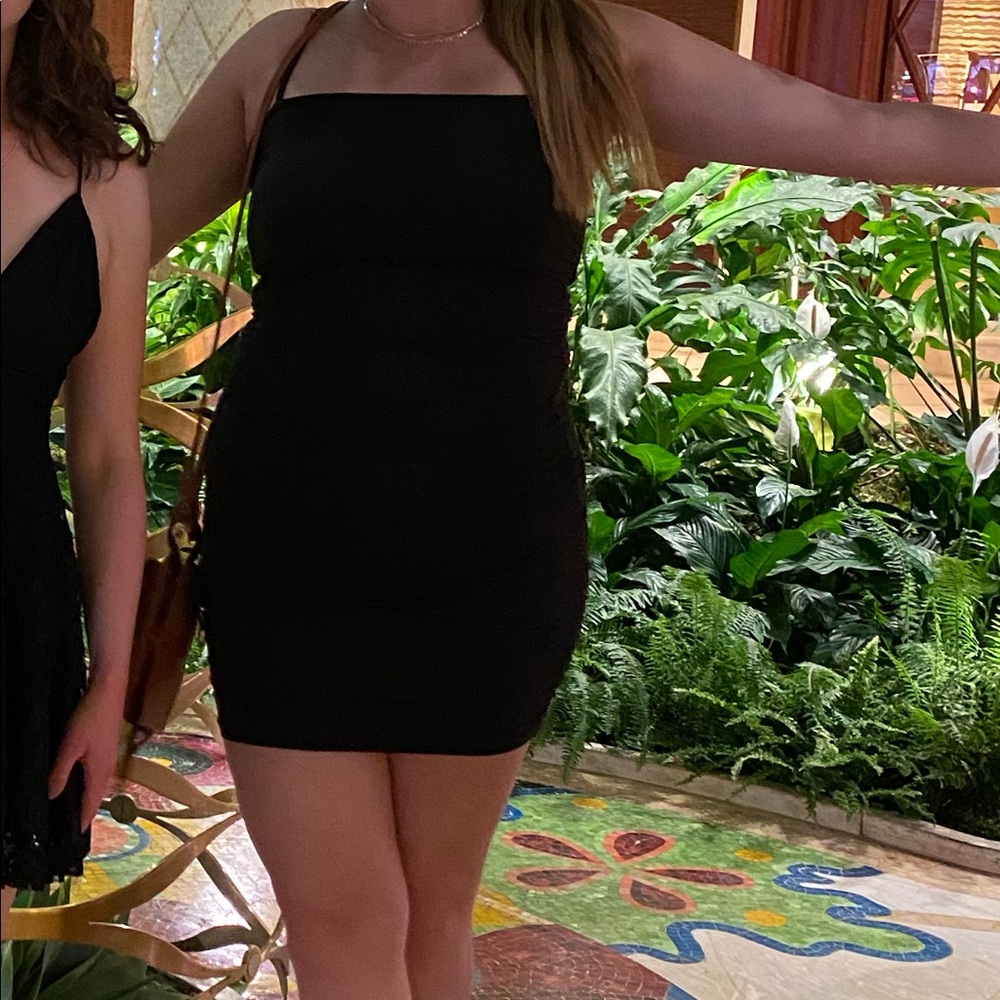 Black form fitting dress with side ruching size medium